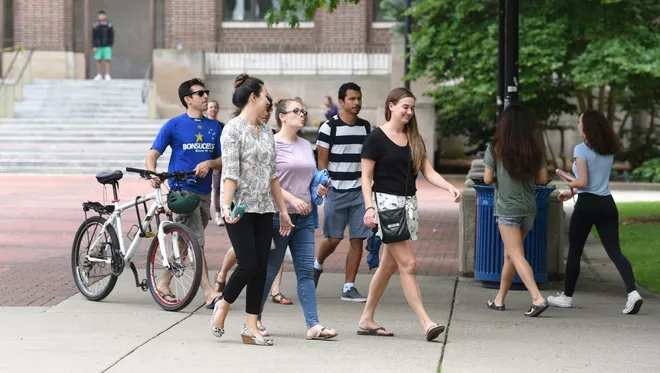 group of people walking on U-M campus