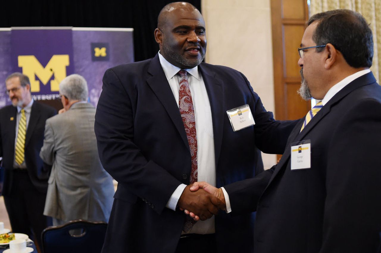 Robert Sellers shaking hands with man